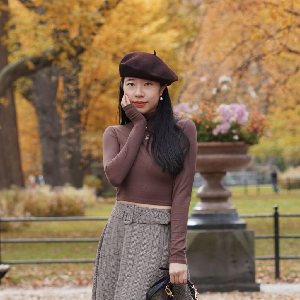 Vivian Tang poses in Central Park with fashion blogger content creator